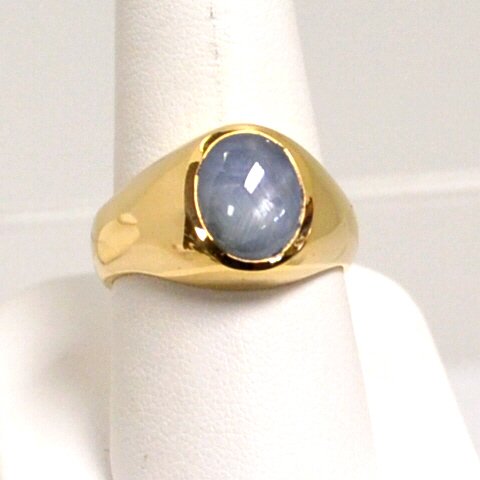 Man's Gray Star Sapphire ring: Man's gray star sapphire ring with oval shaped sapphire measuring 11x8mm, bezel set in high polished setting, finger size 91/2. 9.6gm