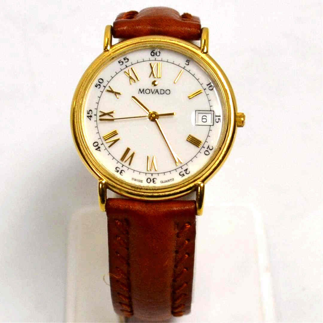 Man's Movado Roman Dial Watch: Man's Movado dress watch model 87-A4-887 with white roman dial and date, swiss quartz movement, 32mm case size, water resistant with tan leather band. Comes with extra band.