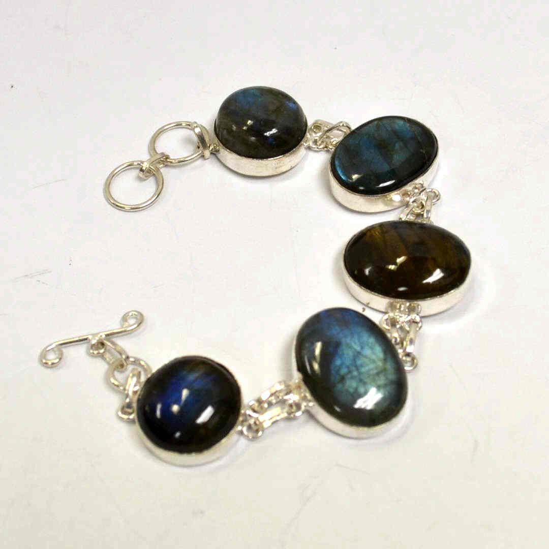 Sterling Blue Labradorite Bracelet: Sterling blue labradorite bracelet with 2 round and 3 oval shaped labradorite measuring 3/4" in diameter along with 1x3/4", bezel set , 8" in length with adjustable clasp.