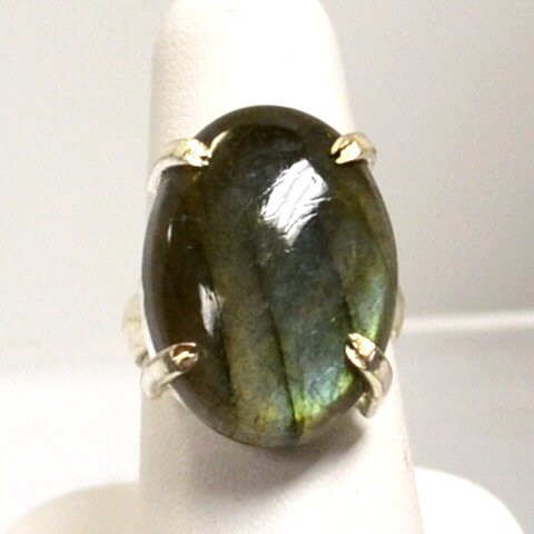 Sterling Blue Labradorite Ring: Sterling blue labradorite ring measuring 1x3/4", prong set with finger size 7.