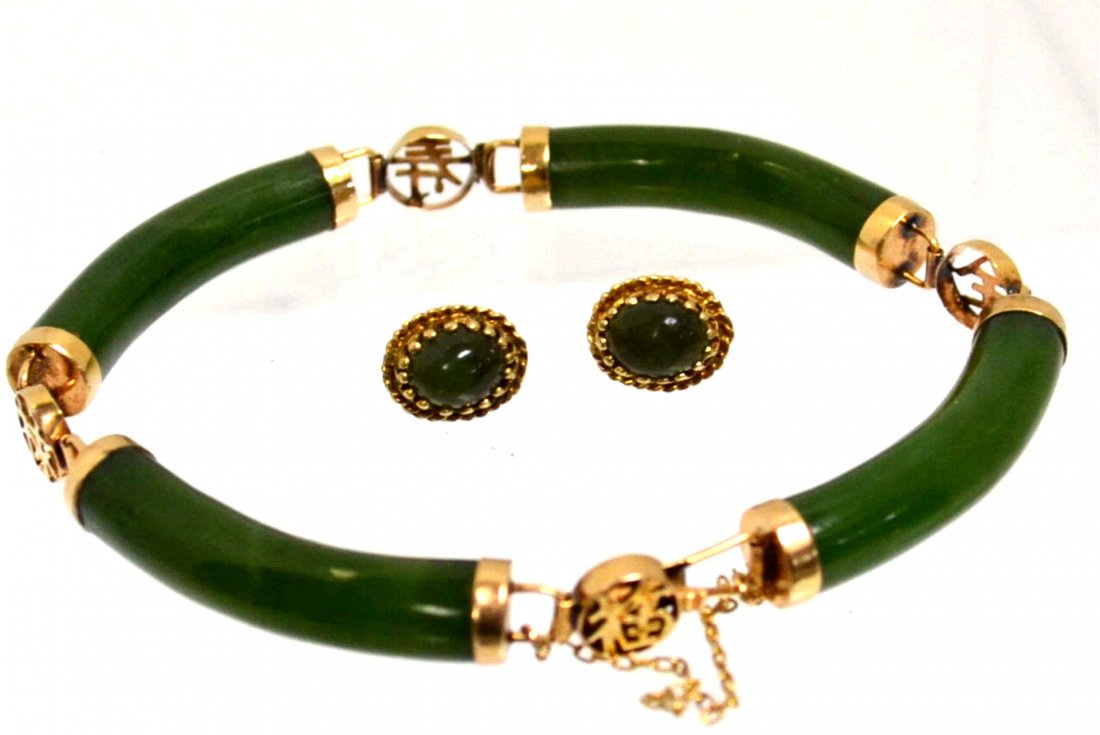 14kyg Green Jade Bracelet & Earrings: Lady's 14kyg green jade bracelet with 4 pieces of green jade along with 14k separators and clasp with safety chain. Also 14kyg jade earrings measuring 11x9mm.