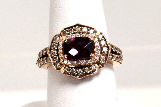 14k LeVian Rhodolite & Diamond Ring: 14k rose gold LeVian garnet and diamond ring with checker top rhodolite garnet measuring 8x6mm surrounded by white and chocolate diamonds and down the shoulders approx. 1ctw and finger size 63/4. 6gm