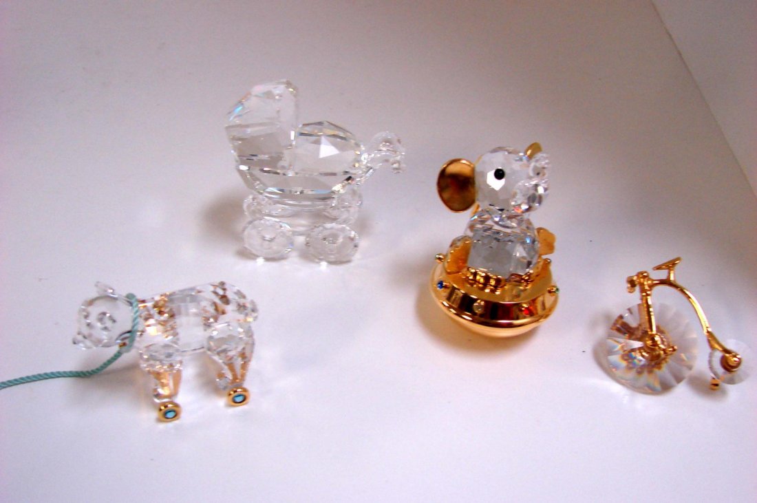4 Swarovski: Carriage, Toy Elephant, Bear, Bike: 4 Swarovski: Baby Carriage #199 197, Toy Elephant, Teddy Bear Toy on Wheels, Farling Bicycle, all with original boxes.
