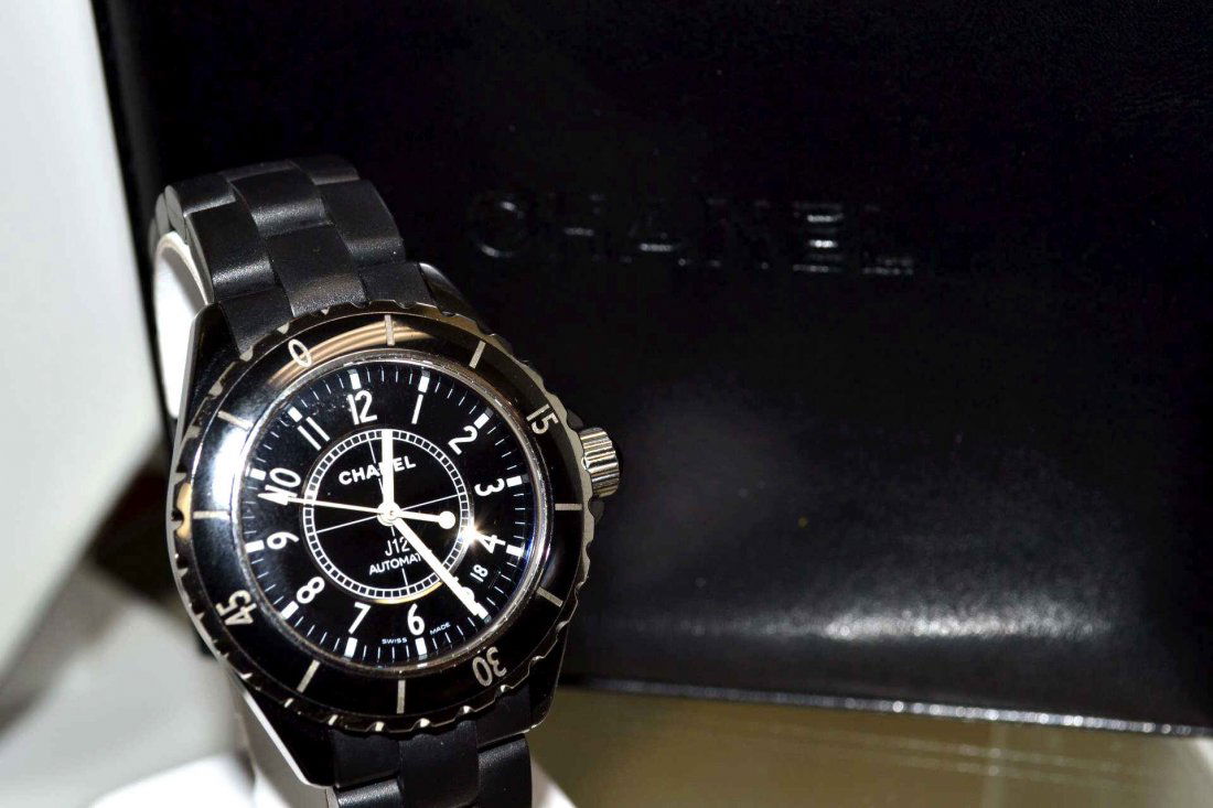 J12 Chanel Etanche Ceramic Watch: Lady's Chanel J12 ceramic watch with black dial and date, automatic Swiss movement, sapphire crystal water resistant to 200m, black ceramic case and band and deployment buckle. Comes with box and manu