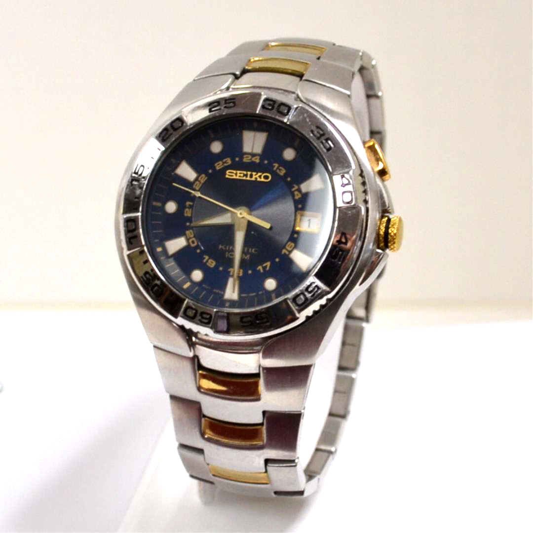 Man's Seiko Kinetic Watch: Man's Seiko Kinetic watch ,stainless steel with gold accents, blue dial and date and water resistan to 100m.