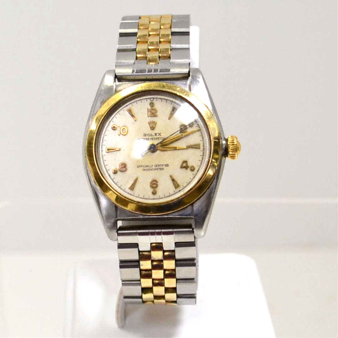Vintage Rolex Oyster Bubble Back Watch: Vintage stainless and 14kyg Rolex Oyster Perpetual bubble back watch with gold dial and hands, black second hand, stainless case with 14kyg bezel and crown, auto mechanical movement and generic stainl