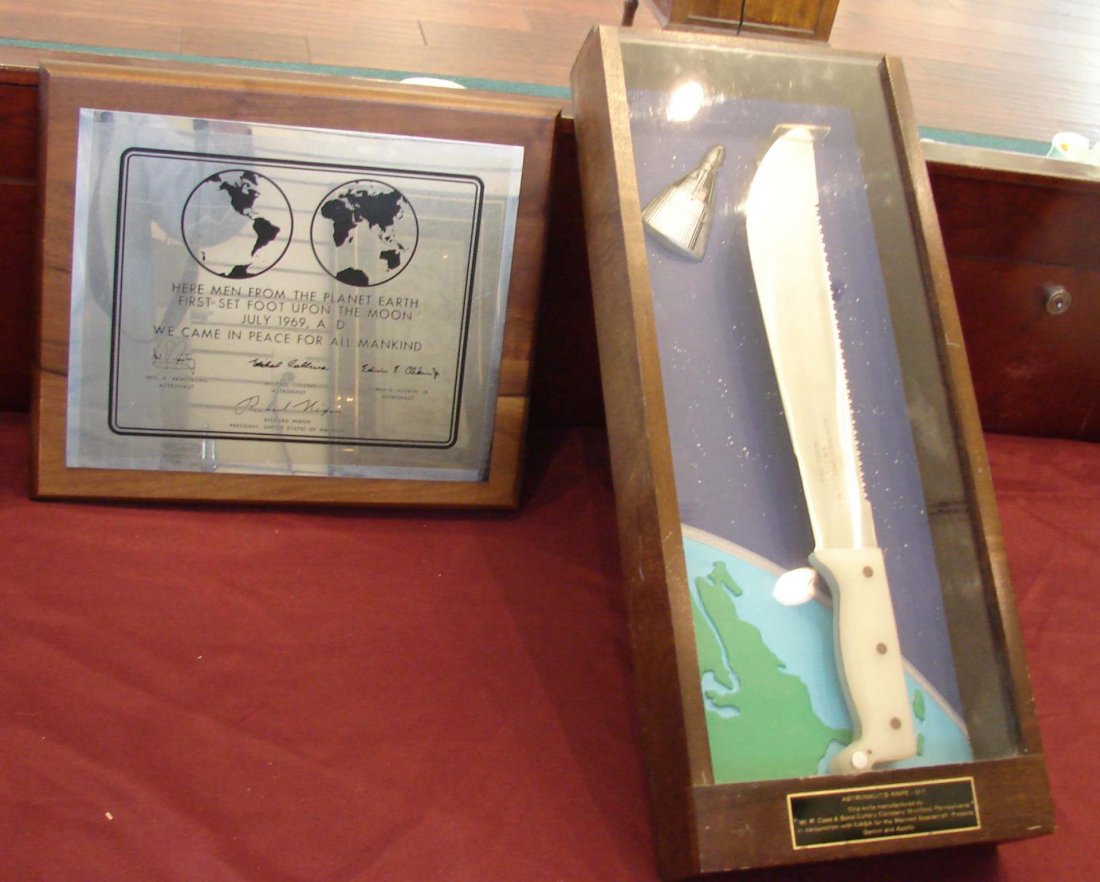 Astronaut's Knife & Moon Landing Plaque: Astronaut's knife in a shadowbox. Mfg. by W. R. Case & Sons in Pa. in conjunction with NASA for the Manned Spacecraft Projects, GEMINI & APOLLO. 21" x 9". Plaque created in 1969 to commemorate moon la