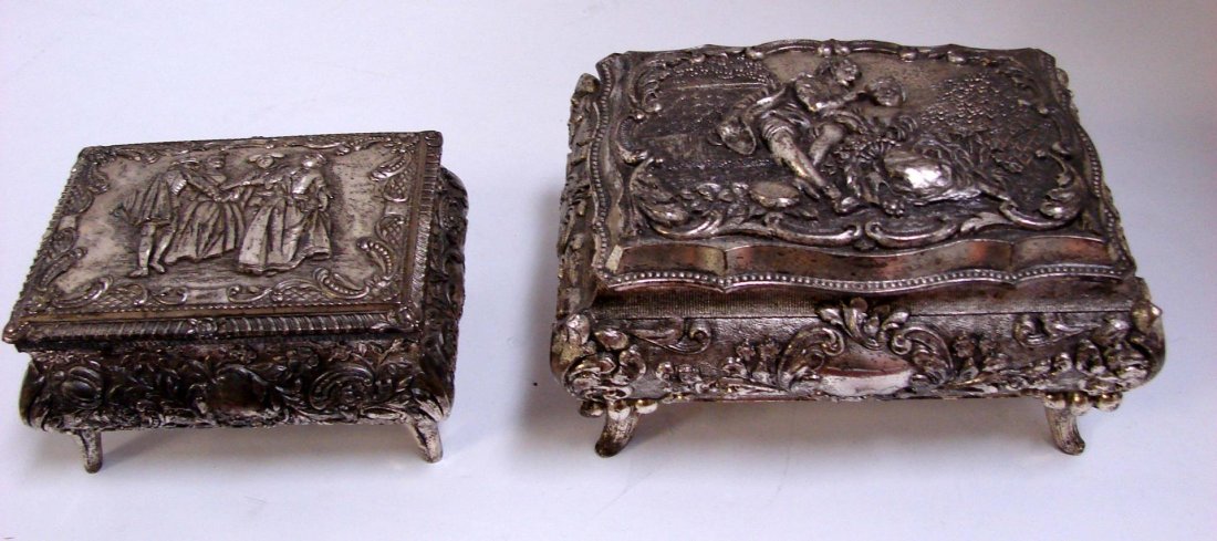 2 Elaborately Decorated Pewter Jewelry Boxes: 2 Elaborately Decorated Pewter Footed Jewelry Boxes, 4" and 5 1/4" wide respectively.