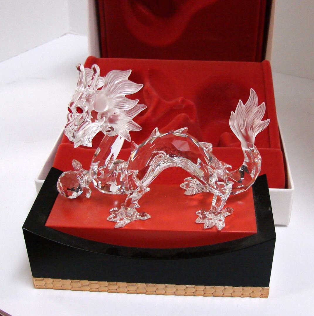 Swarovski Dragon from "Fables and Tales" Series: Swarovski Dragon from "Fables and Tales" Series on a wooden stand with original box and packing. There is a tiny chip on the hair on the dragon's head; see photo.