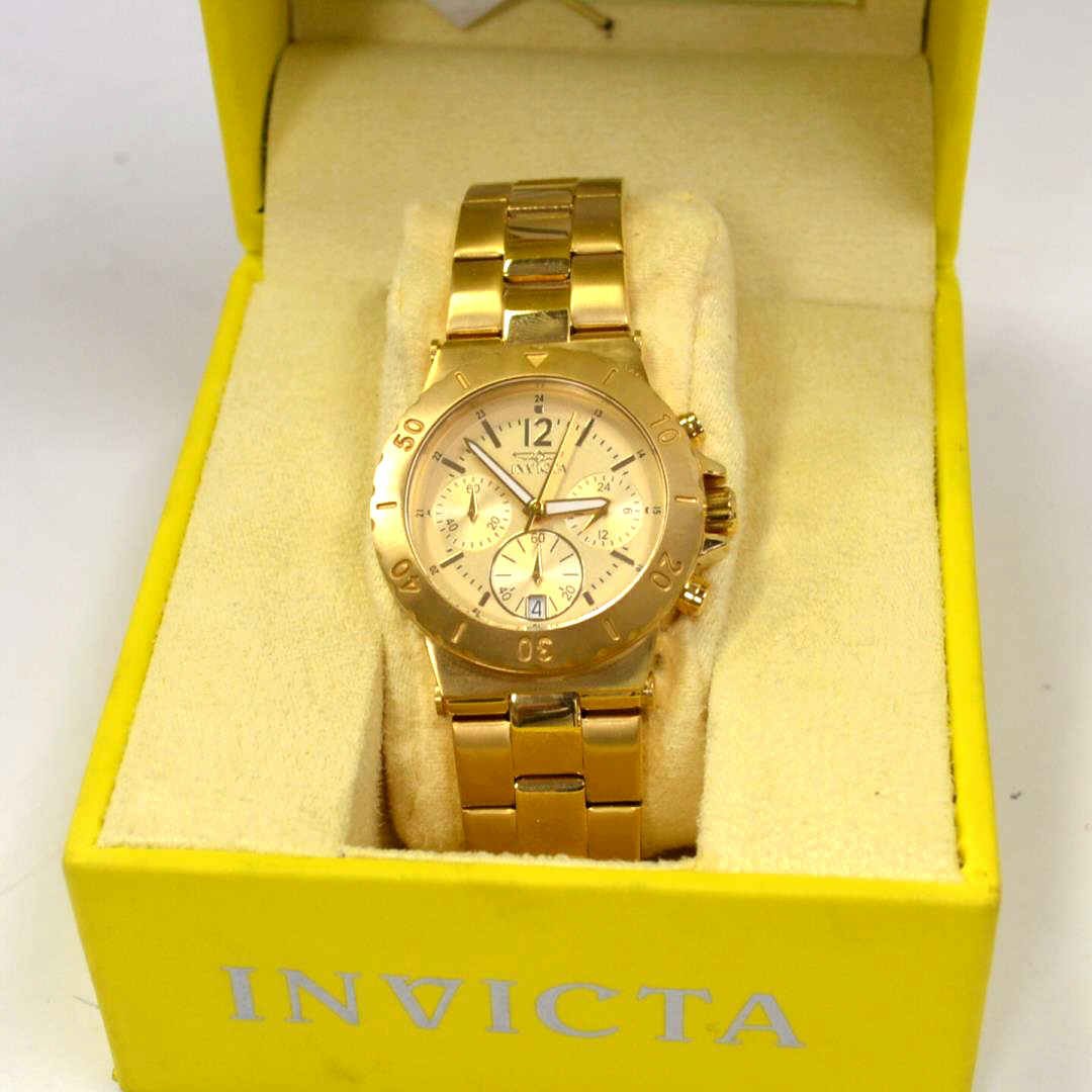 Invicta Trinite Night Glow Watch: Man's Invicta Trinite Night Glow Chronograph watch with gold dial and date, water resistant, sapphire crystal, gold plated finish, box and papers. NEW!
