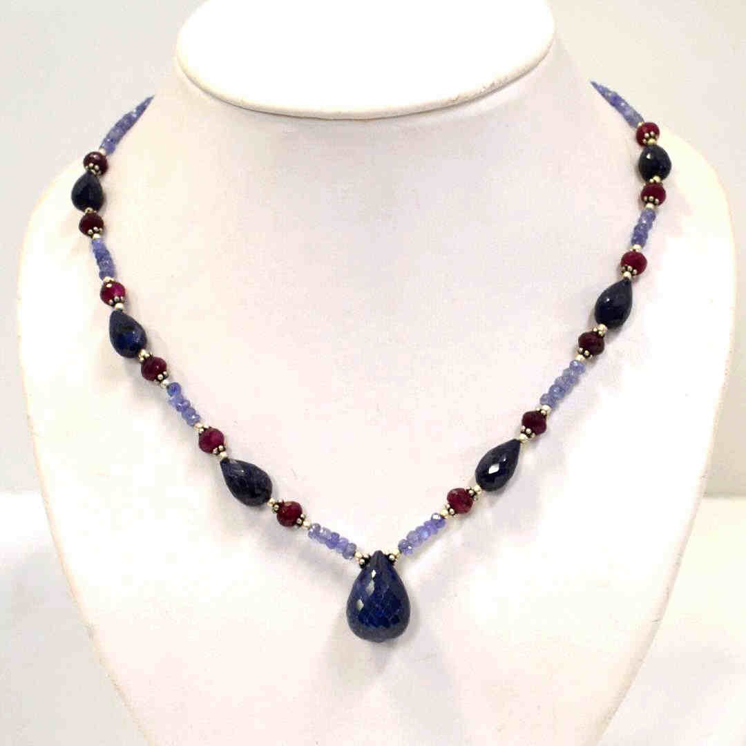 Blue Sapphire, Ruby & Tanzanite Necklace: Colored stone necklace with briolette blue sapphire beads alternating with round rubies and tanzanite, sterling separators , 20" in length with sterling clasp.