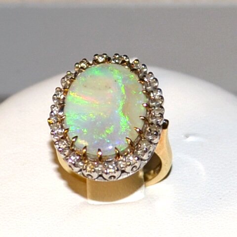 14k 2tone Opal & Diamond Ring: 14k 2tone opal and diamond with oval shaped opal matrix measuring 20x15mm, green, blue and orange color, surrounded by 18 round prong set diamonds, .36ctw mounted in white gold and yellow gold shank, 