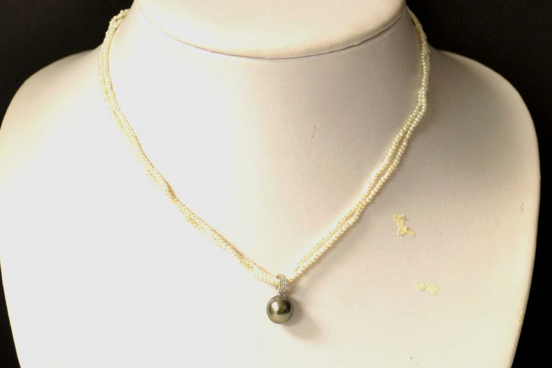 Seed Pearl Necklace with Black Tahitian Pearl: Black Tahitian pearl necklace with one black Tahitian pearl measuring 10mm hanging from diamond bale. Necklace is made up of 1 1/2mm seed pearls with 14kwg clasp.