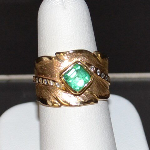 14kyg Emerald & Diamond Ring: 14kyg emerald and diamond ring with square step cut emerald weighing .85ct, bezel set with 8 flush set round diamonds on either side, .20ctw, Florentine and high polished 15mm tapered band, finger siz