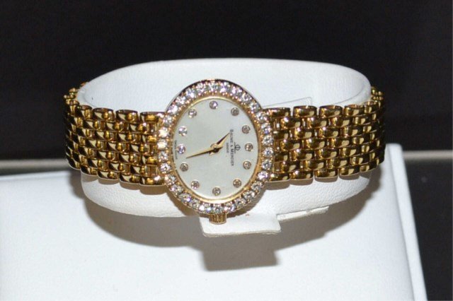 14kyug Baume & Mercier Diamond Watch: 14kwg Baume & Mercier diamond watch with mother of pearl diamond dial, .90ct diamond bezel, Swiss quartz movement, 22mm oval case, 12mm panther band and good running condition.18.8gm