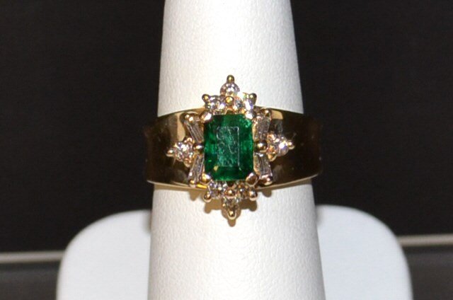 14kyg Emerald & Diamond Ring: 14kyg emerald and diamond ring with one emerald cut emerald weighing 1.03ct,. surrounded by round and baguette diamonds, .50ctw, 7mm tapered band, finger size 7. 6.6gm