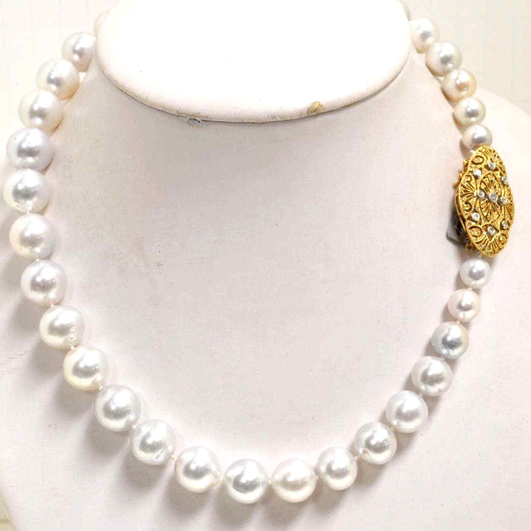 White Tahitian Pearl Necklace 11-15mm: Lady's 20" strand of white Tahitian pearls graduated, measuring 11-15mm white pearly white luster, single knotted with 14kyg diamond filigree clasp with 9 bezel set diamonds weighing .30ctw. 12971