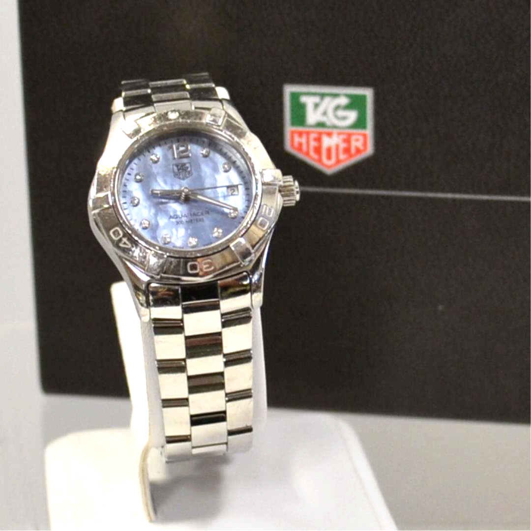 Lady's Stainless Tag Heuer Aquaracer Watch: Lady's stainless Tag Heuer Aquaracer watch with blue mother of pearl diamond dial, date, sapphire crystal, water resistant to 300m, box and papers.