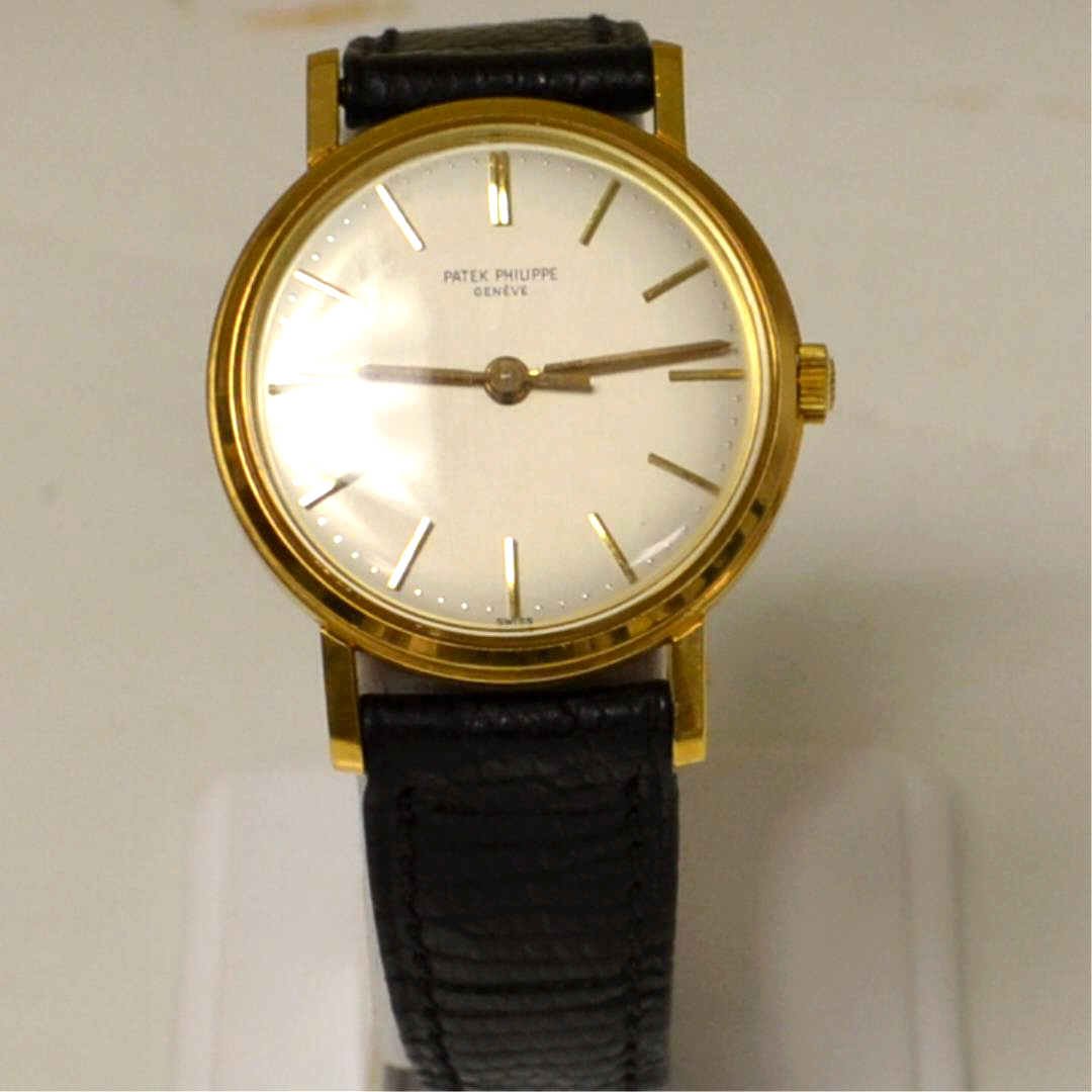 Man's 18kyg Patek Philippe Watch: Man's Patek Philippe watch with silver stick dial, 18 jewel movement, rare sweep second hand, 34mm case and original black leather strap with 18k Patek Philippe buckle. Good working condition.