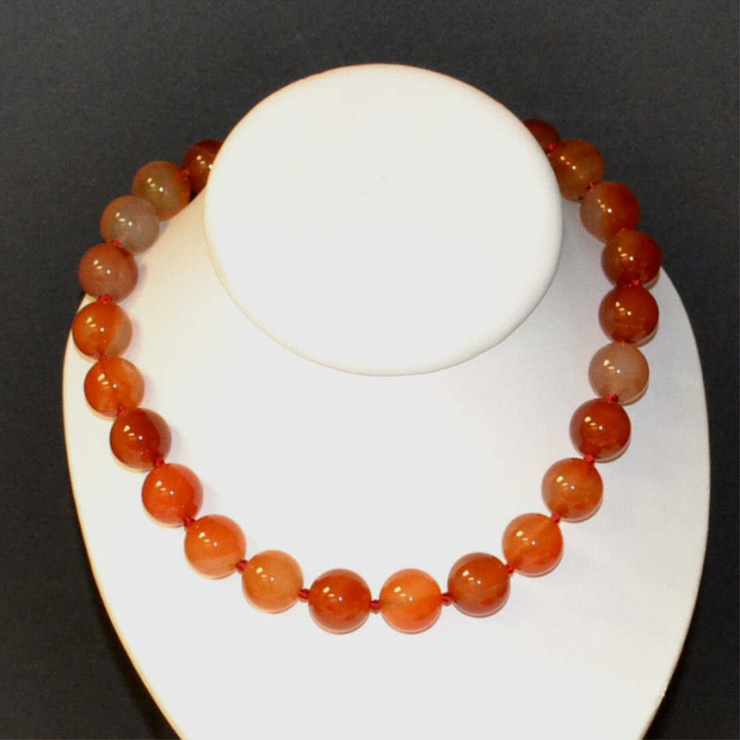 Carnelian Bead Necklace: Carnelian bead necklace with 16mm beads, single knotted, 18" in length with silver circle clasp.