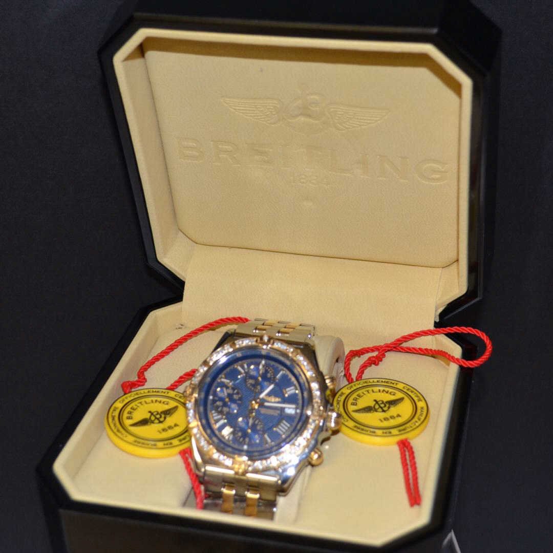 Man's Breitling Crosswind Watch 18k/stainless: Man's 18k and stainless Breitling Navitimer Crosswind watch with blue dial,diamond bezel, 3 sub dials, date, sapphire crystal, 200m dive, 18k buttons, automatic movement, original box and papers,