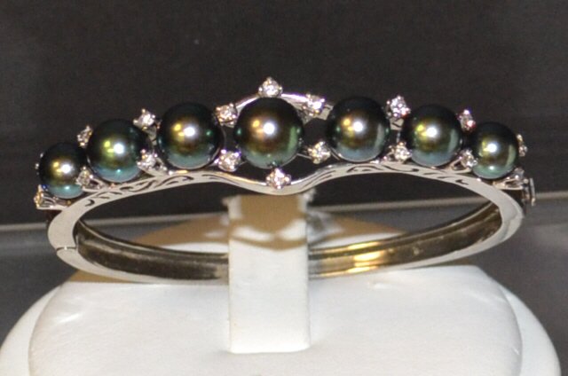 14kwg Pearl & Diamond Bangle Bracelet: 14kwg diamond and pearl bracelet with 7 black Tahitian pearls measuring 7-8mm, alternating with 18 prong set diamonds weighing .54ctw, 2 1/4" inside diameter. 23.5gm