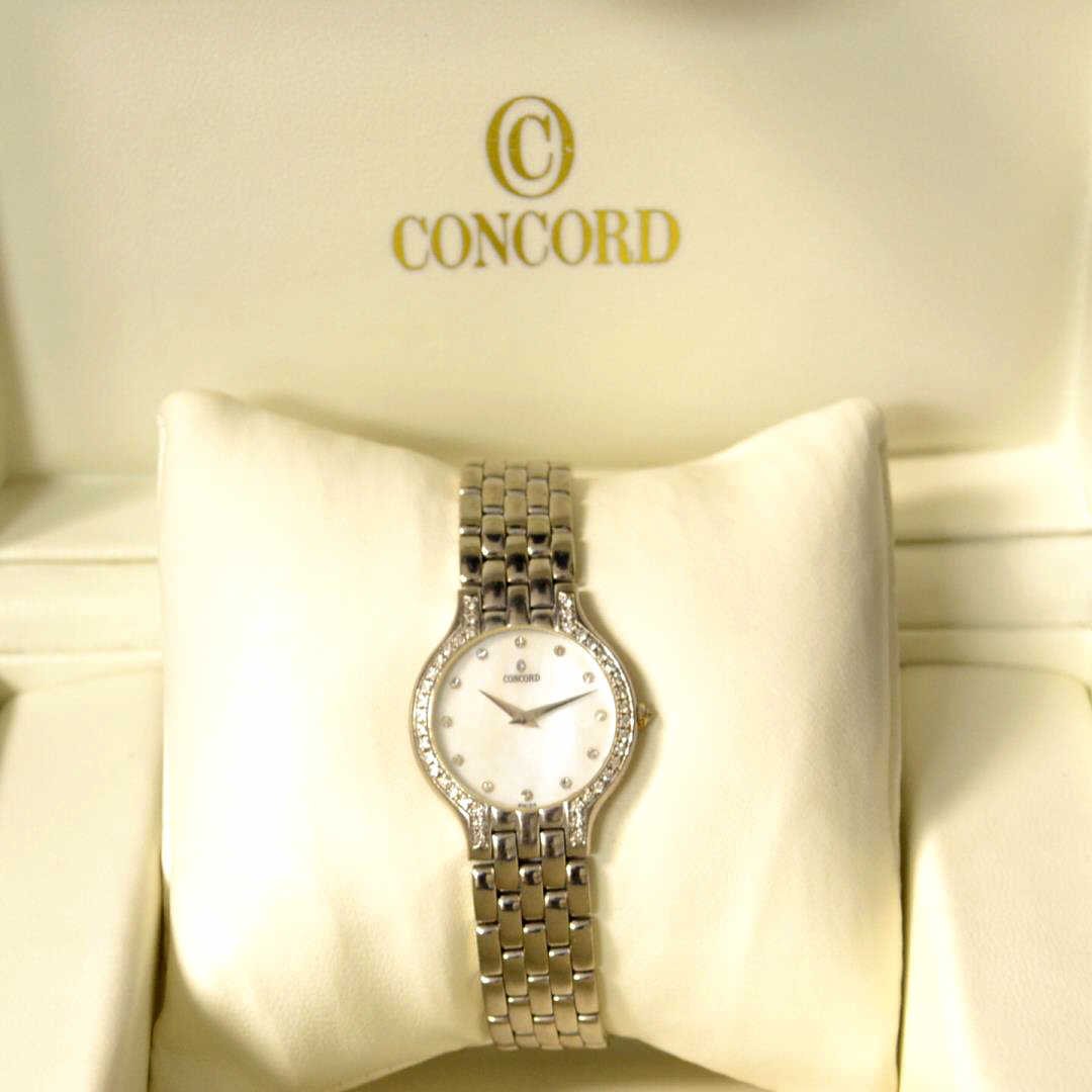 Lady's 18kwg Concord Les Palais Diamond Watch: Lady's 18kwg Concord Les Palais diamond watch with mother of pearl diamond dial, diamond bezel, Swiss movement, water resistant and panther band with hidden clasp. Comes with box and papers.