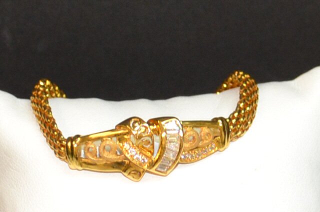 22kyg Heart Bracelet: 22kyg heart bracelet with CZ baguettes, along with prong set CZs, heart design, swirls on either side, panther link bracelet, 7 1/2" in length. 12.3gm