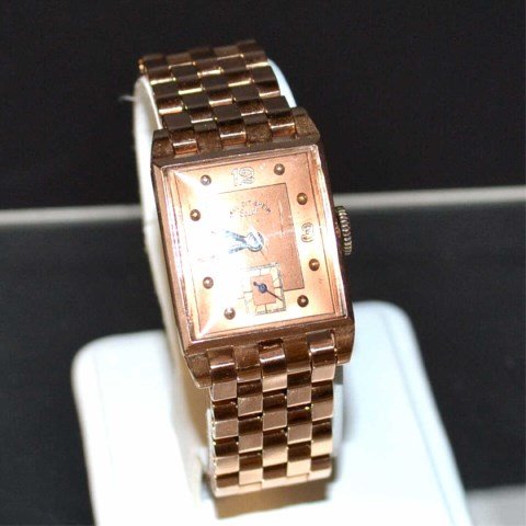 Vintage 14k Rose Gold Paul Ditisheim Watch: Man's 1940's 14k rose gold Paul Ditisheim Solvil watch with rectangular face, mechanical movement , 22mm case, panther link bracelet ,7" in length and 5/8" in width. Has extra link. 55gm