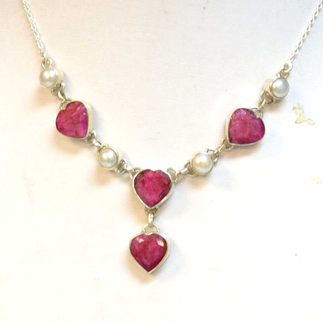 Sterling Ruby & Pearl Necklace: Sterling ruby and pearl necklace with 4 heart shaped opaque rubies weighing 32ctw, along with bezel set pearls measuring 7mm, 20" adjustable length with lobster clasp.