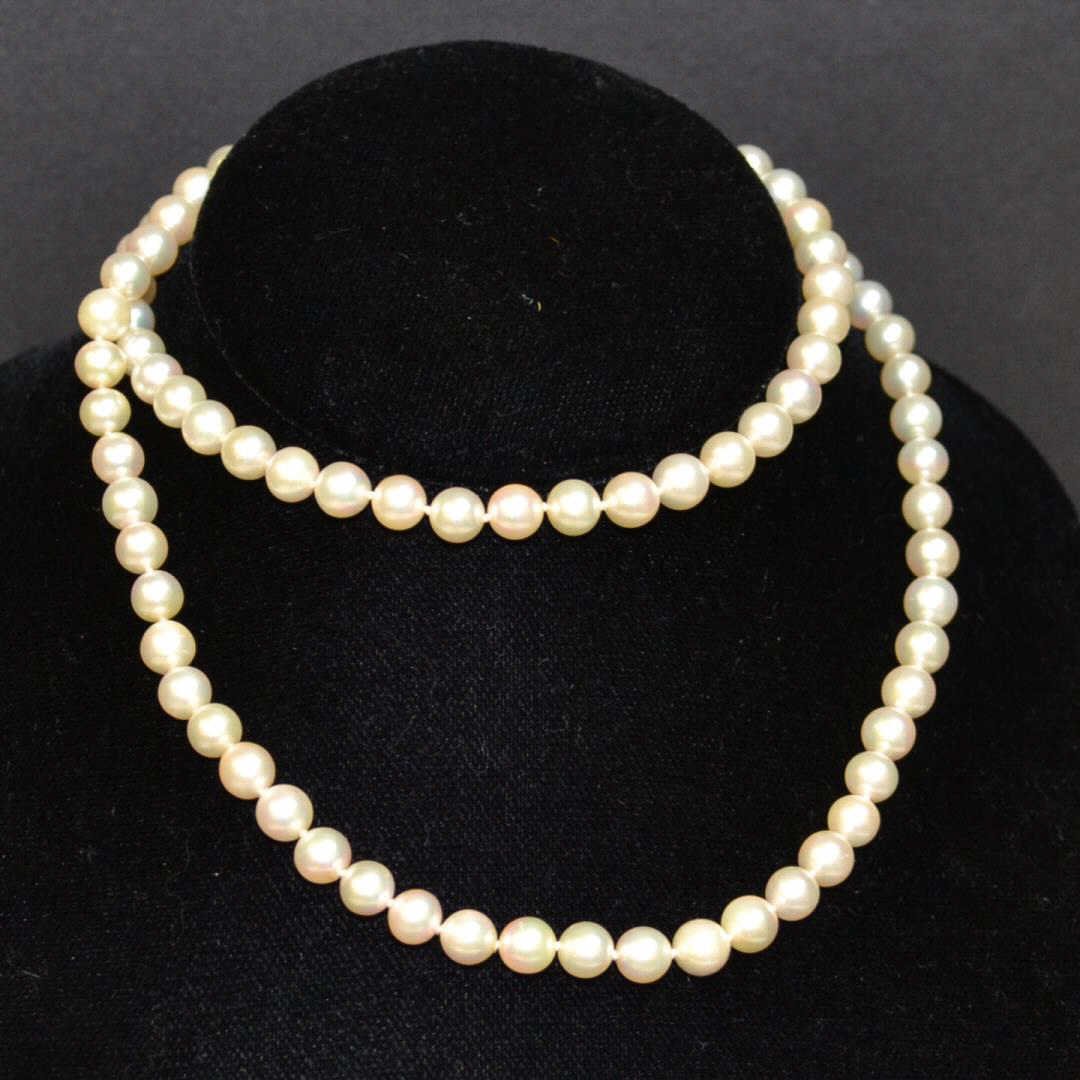 26" Pearl Necklace with Diamond Caps: 26" strand of cultured pearls, 6.5mm, single knotted, creamy white with high luster and 14ky diamond clasp.