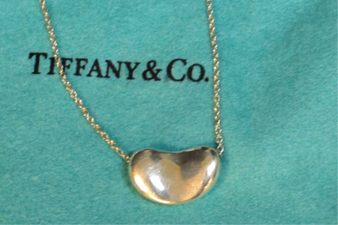 Sterling Bean Necklace For Tiffany & Co: Vintage 70's sterling bean necklace by Elsa Peretti for Tiffany, 12mm in width with 16" link chain.