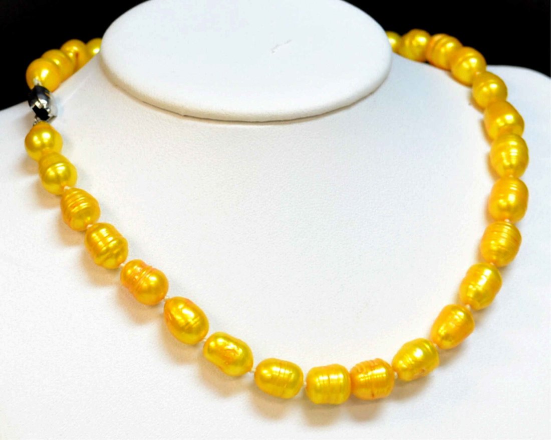 Golden Yellow Tahitian Pearl Necklace: One strand of Tahitian pearls with 10-11mm pearls, golden yellow color, single knotted, 18" in length with sterling clasp.