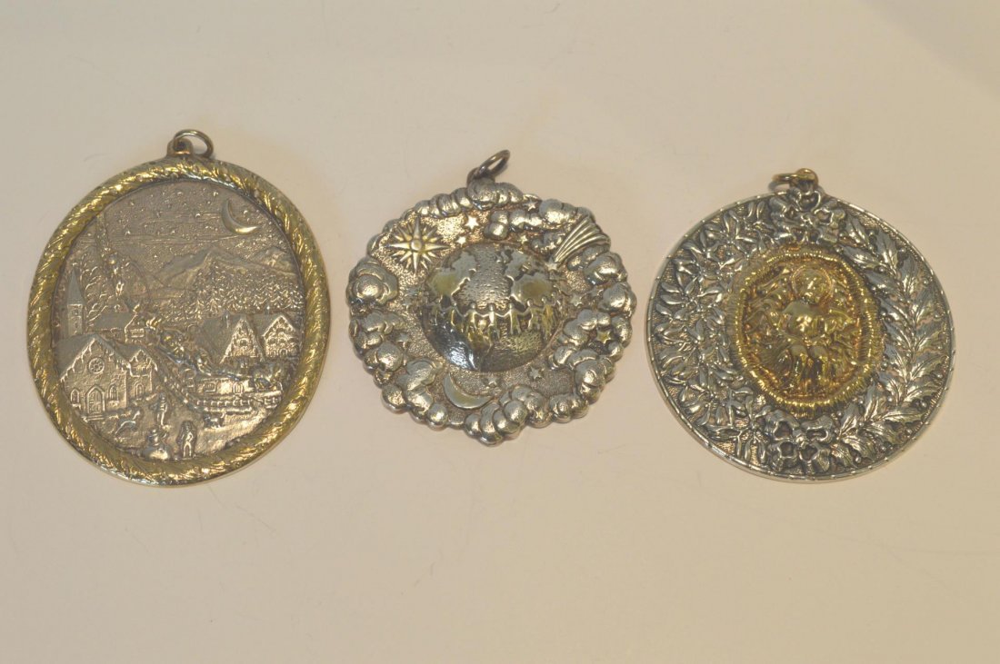 Three Sterling Silver Christmas Ornaments: Three Sterling Silver Christmas Ornaments. Three Buccellati, repousse ornaments, 3" to 4 1/2"l. with two cloths and box, 6oz t.