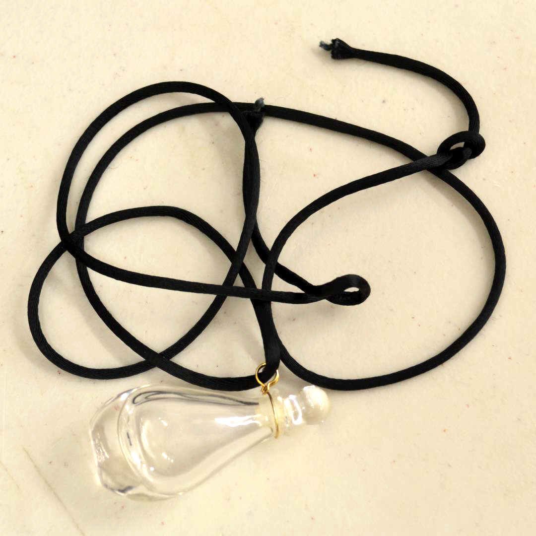 Vintage Halston Perfume Bottle: Vintage Halston miniature perfume bottle necklace,2 1/4" tall with 30" nylon cord and 14kyg box chain.