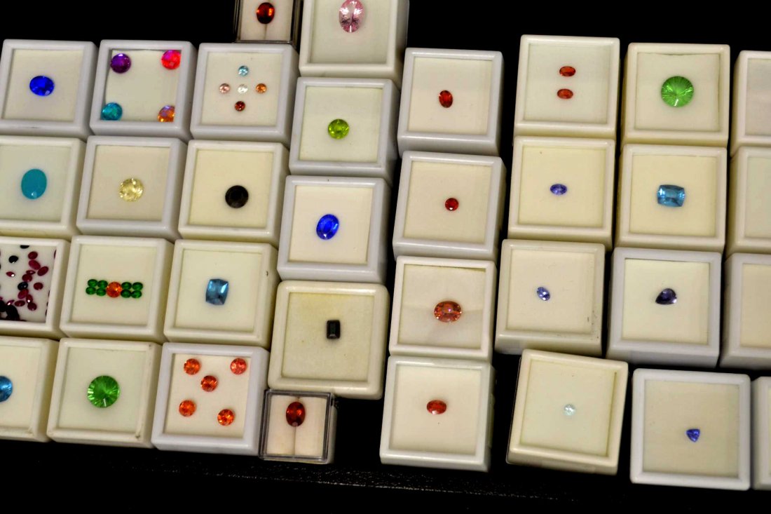 Lot Of Colored Stones: Lot of 34 colored stone boxes including andesine, tanzanite, pink topaz, peridot, chalcedony, zandrite and more.