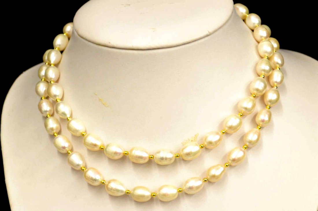 36" Strand Freshwater Baroque Necklace: 36" freshwater semi baroque necklace with 12mm pearls, cream color, alternating with gold tone beads and circle clasp.