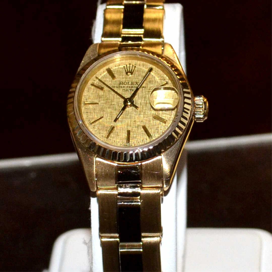 Lady's Gold Rolex Datejust Watch: Lady's gold Rolex Datejust watch with 14kyg case, datejust movement with nugget like date dial, auto mechanical movement, and 18kyg oyster bracelet. Great condition!