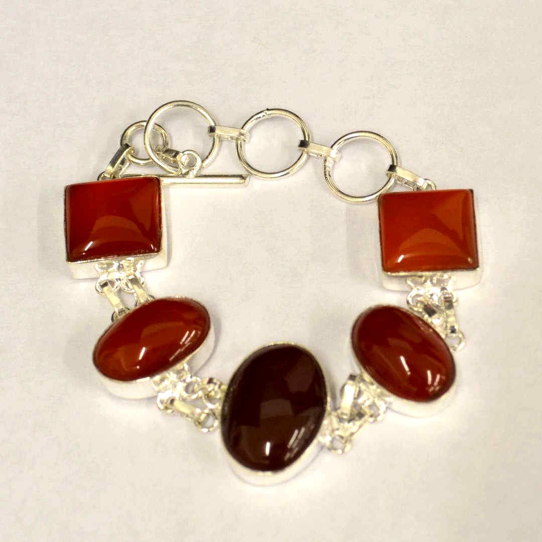 Sterling Carnelian Bracelet: Sterling carnelian bracelet with square and oval shapes, bezel set , 8" in length with toggle clasp.