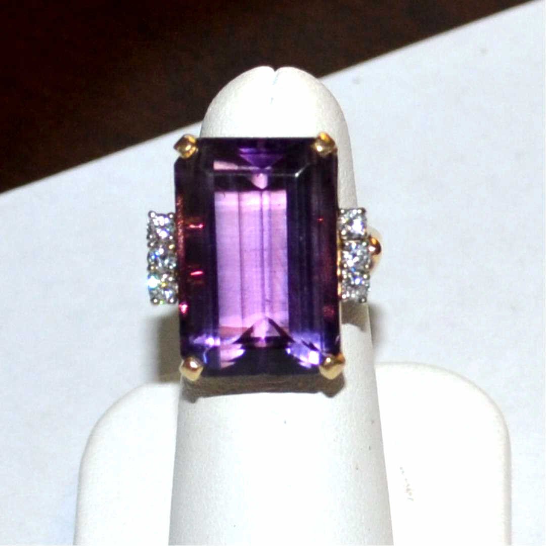 14kyg Amethyst & Diamond Ring 20ct: 14kyg amethyst and diamond ring with one emerald cut amethyst weighing approx. 20ct , prong set with 3 round prong set diamonds on either side, weighing .30ctw, split shank and finger size 5. 11.9gm