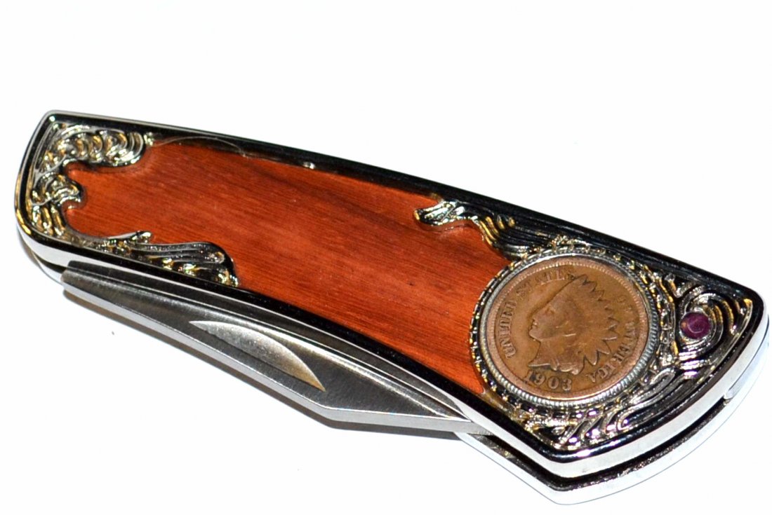 1903 Indian Head Penny Pocket Knife: Wood grained pocket knife with 1903 Indian head penny, 3" stainless blade, 3 1/3" in length with round ruby. TH338