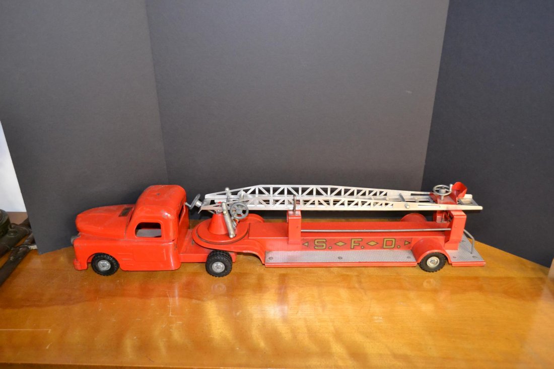 lot of emergency vehicle toys: structo toy ladder fire truck. Red truck measures 33 inches across. Also nylint emergency ambulance. Red in color with white roof top. Measures 15 inches across.