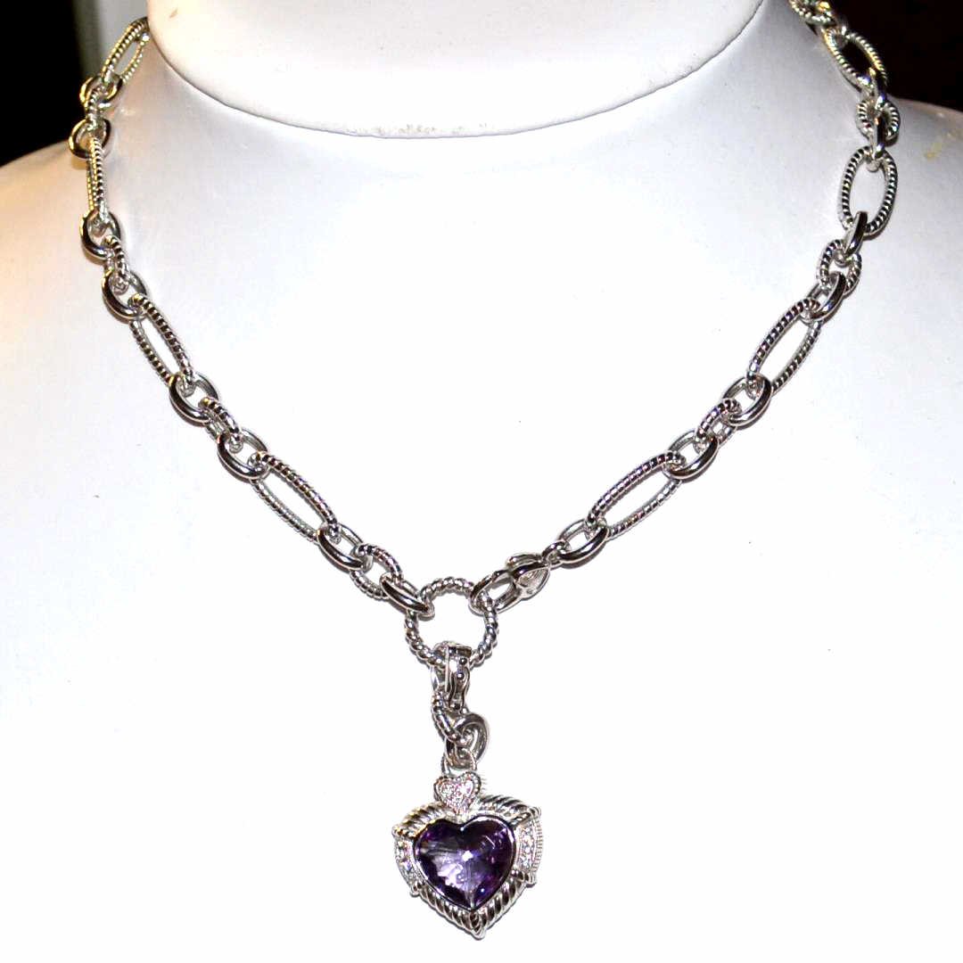 Sterling Amethyst Heart Necklace Judith Ripka: Sterling amethyst necklace by Judith Ripka with 7ct heart shaped amethyst in a enhancer pendant design, prong set CZs, 18" in length with heart shaped lobster clasp.