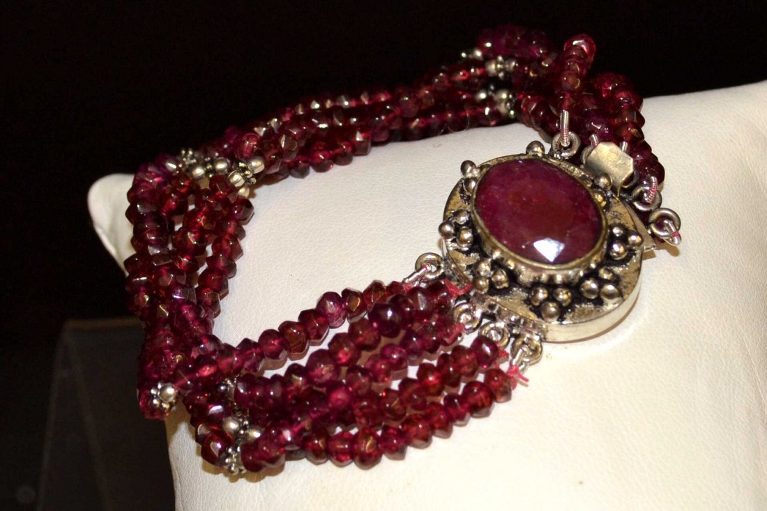 Sterling Rhodolite Bracelet With Ruby Clasp: Rhodolite bead bracelet with 5 strands of 4mm rhodolite beads with sterling separators and sterling clasp with opaque natural ruby, 7"in length.