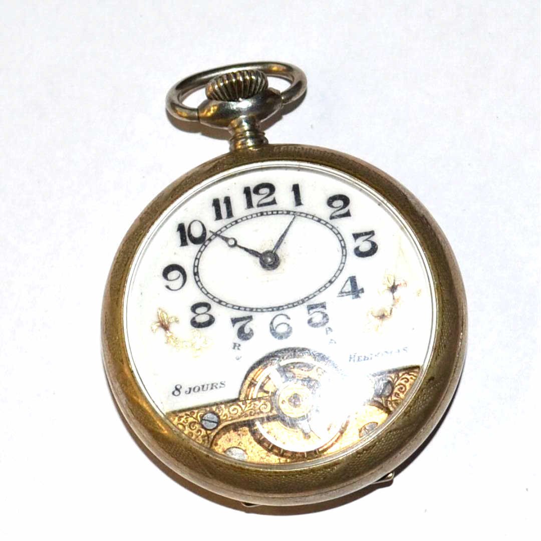 Antique Swiss Hebdomas Pocket Watch: Antique 1900s Swiss 8 day Hebdomas pocket watch with with white enamel dial, black numbers and gold leaf Fleur de Lis, 49mm silver case and in non running condition.