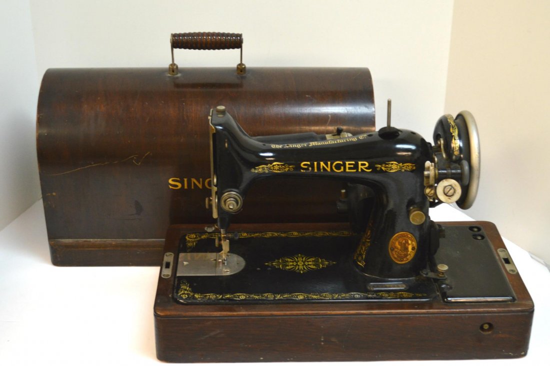 Portable Singer Sewing Machine: Singer Sewing Machine. Black lacquered sewing machine with gold decals in a mahogany dome top box. 15 1/2"h. S/N AA712059. Circa 1925.
