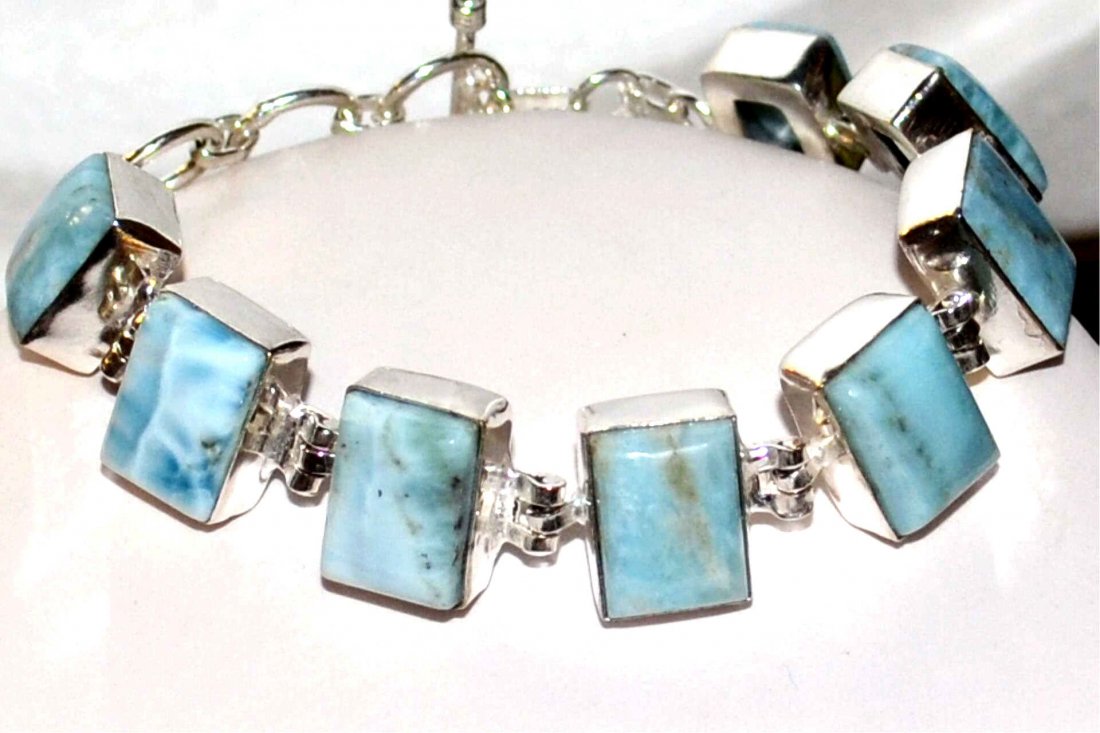 Sterling Caribbean Larimar bracelet: Sterling Caribbean larimar bracelet with 8 rectangular larimar, measuring 14x10mm graduating to 12x9mm, bezel set, 8" in length with toggle clasp.
