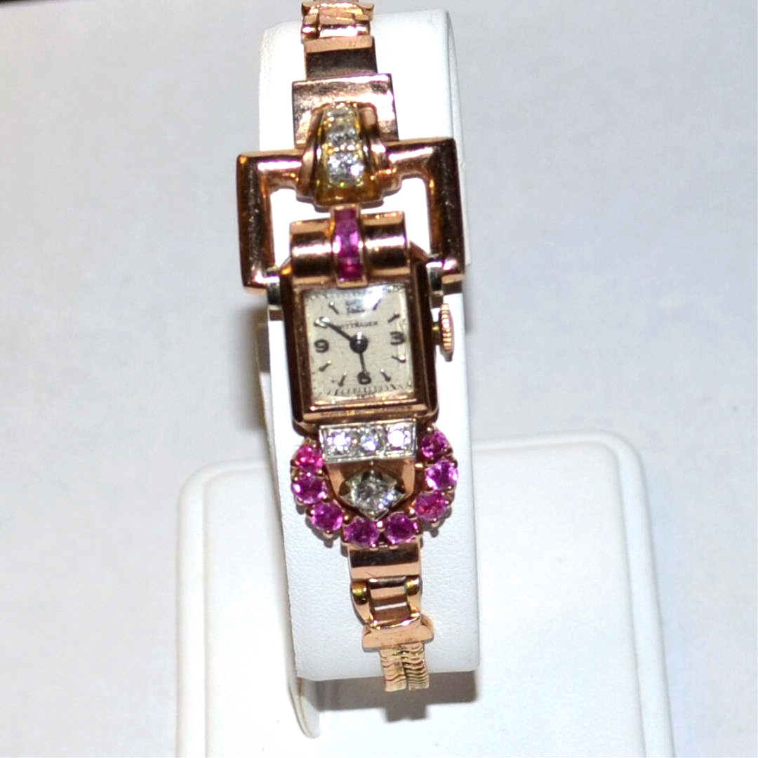 Vintage 14k Rose Gold Diamond & Ruby Watch: Lady's vintage 14k rose gold diamond and ruby Wittenauer deco watch with white dial and black hands, running movement, 8 round diamonds, weighing .36ctw, along with 3 baguette and 8 round rubies and d