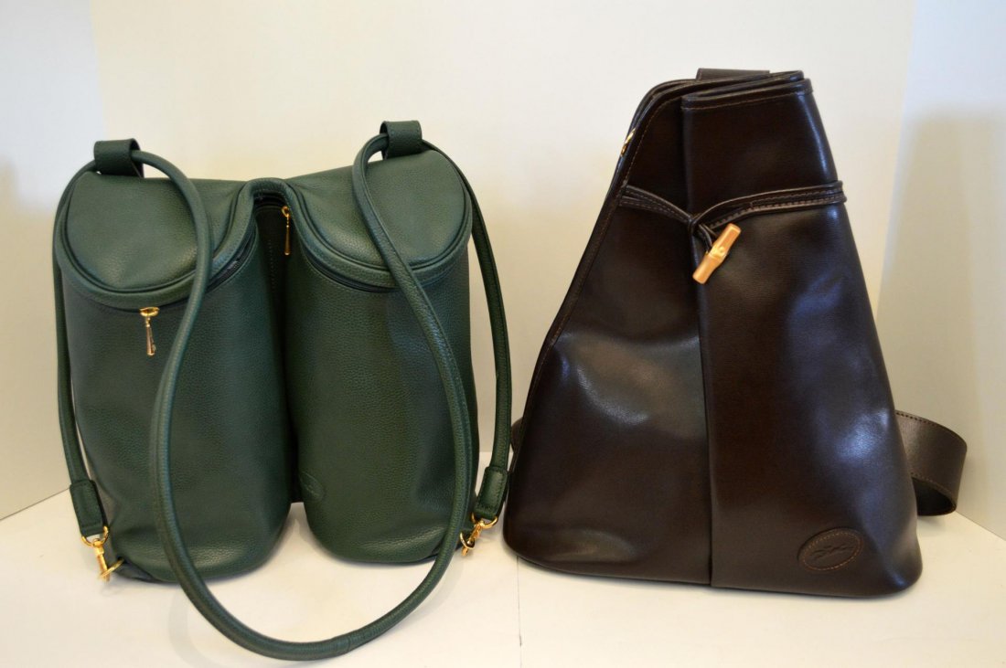 Two Longchamps Calf Skin Leather Shoulderbags: Two Longchamps Calf Skin Leather Shoulderbags. A green shoulder bag/backpack with gold tone hardware, 12"h., and a dark brown shoulder bag in odd shape, 14"h.