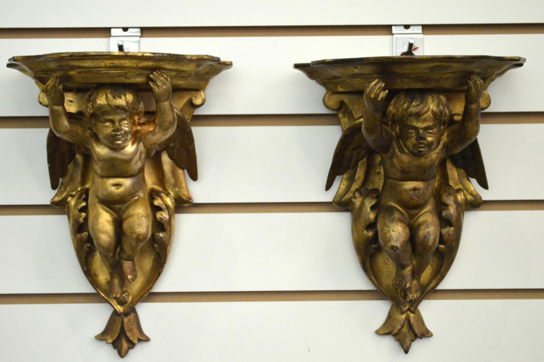 Pair Of Italian Wall Brackets: Pair Of Wall Brackets. Early, gilt wood brackets with cherub decoration, 9 3/4"h.